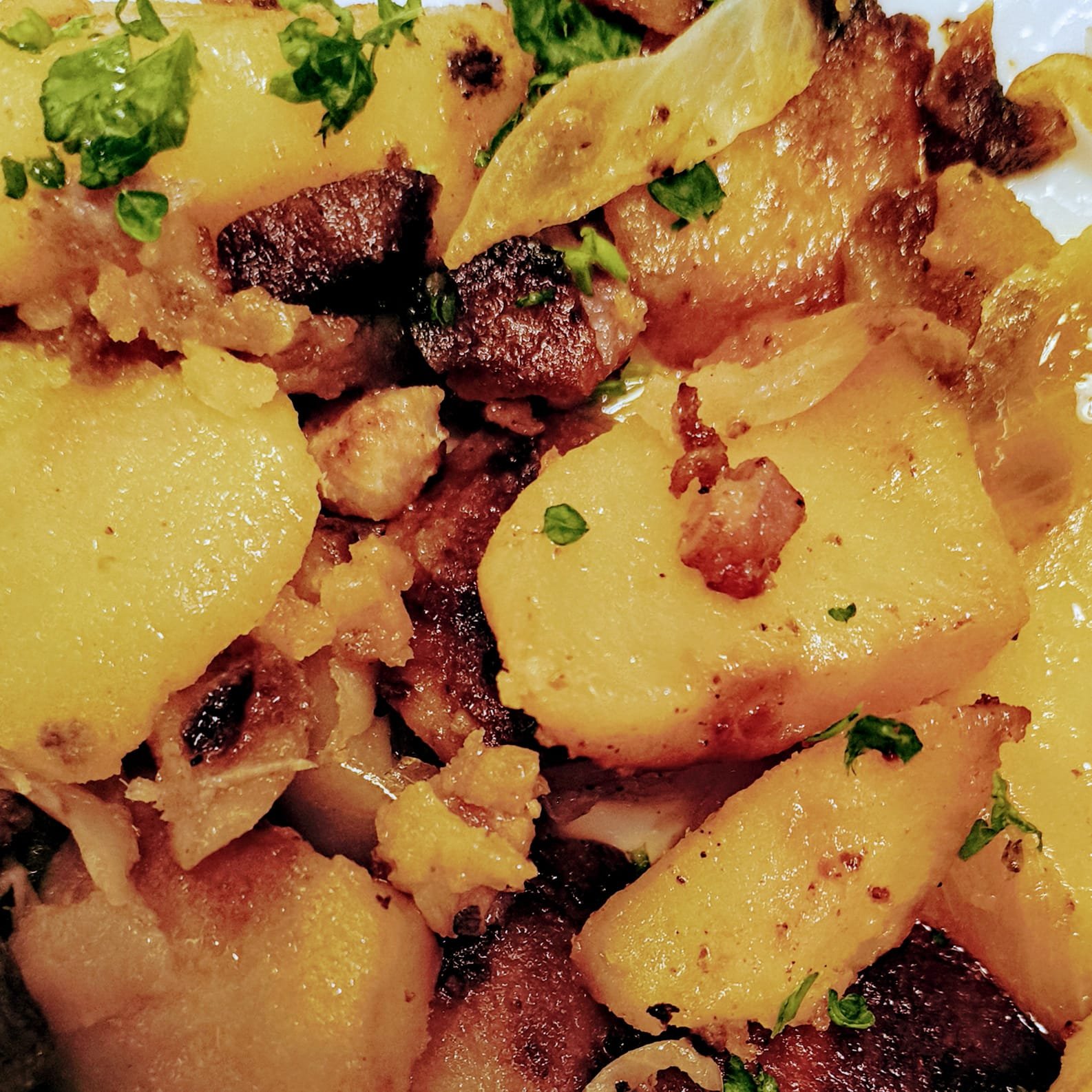 German pan-fried potatoes with caramelized onions on a rustic plate